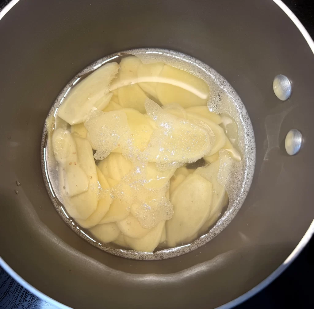 Boiling ginger root in sugar water